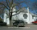 Historic Homestead Presbytery church with white exterior and large trees.